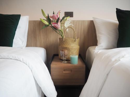 Postel nebo postele na pokoji v ubytování Darley Hotel Chiangmai