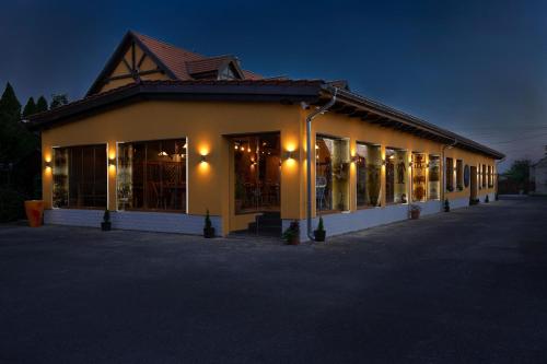 a building with a lot of windows and lights at Radics Panzió Étterem és Pihenő Központ in Letenye