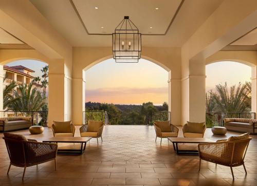 a lobby with chairs and tables and a chandelier at Park Hyatt Aviara in Carlsbad