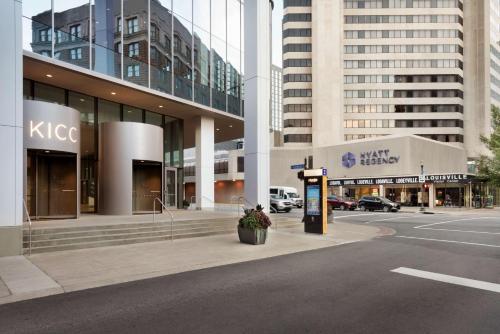 a city street with tall buildings and a parking lot at Hyatt Regency Louisville in Louisville