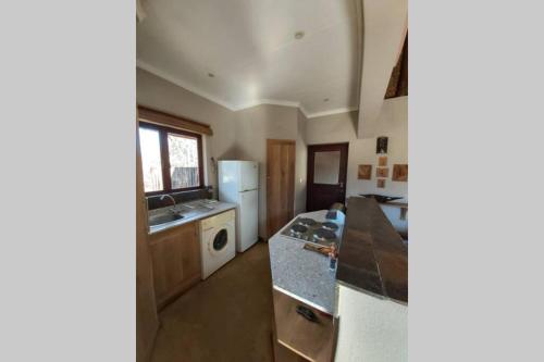 a kitchen with a counter top and a refrigerator at 13 Raptors Lodge in Hoedspruit