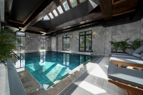 a swimming pool in a house with a ceiling at Industrial 1853. in Kragujevac