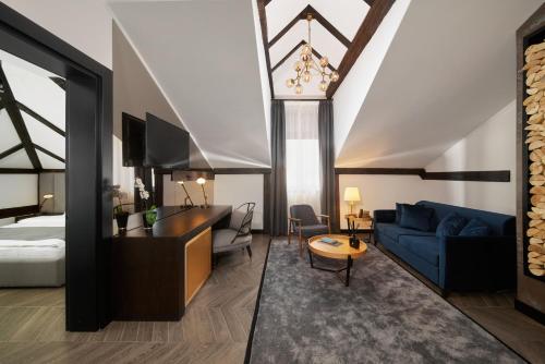a hotel room with a bed and a blue couch at Industrial 1853. in Kragujevac