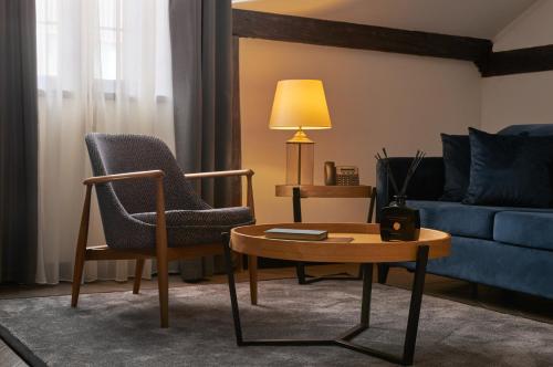 a living room with a chair and a table and a couch at Industrial 1853. in Kragujevac