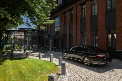 a black car parked in front of a building at Industrial 1853. in Kragujevac