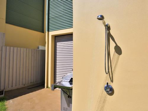 a shower on the side of a building at Thalassa I Pet Friendly I 2 Mins Walk to Beach in Culburra Beach