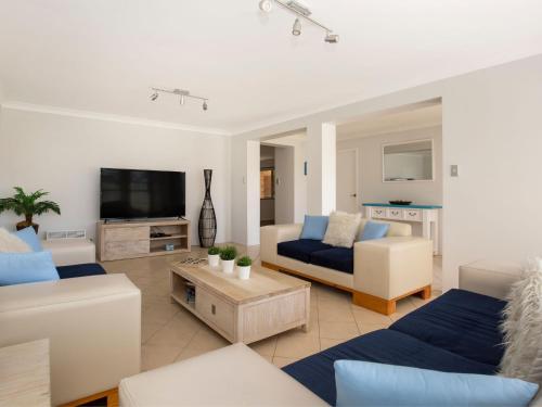 a living room with couches and a tv at Coastaway I Pet Friendly I 3 Min Walk to Beach in Culburra Beach