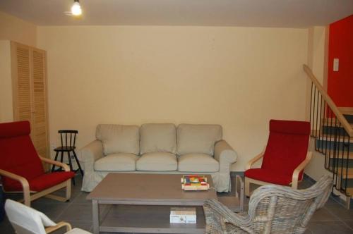 a living room with a couch and two chairs at Le Clos des Haies, Silenrieux in Cerfontaine