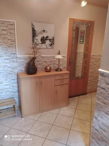 a room with a vase on top of a cabinet at Ferienwohnung- Haus Anna in Papenburg