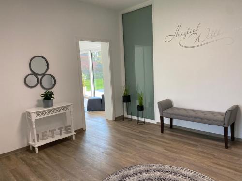 a living room with a chair and a table at Ferienwohnung Jette in Westerstede