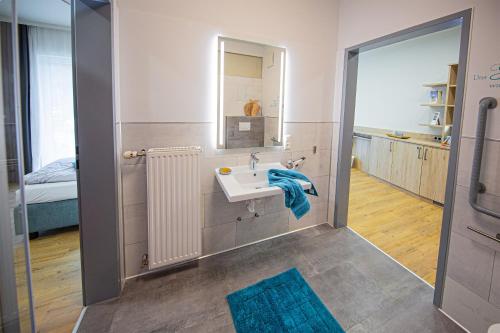a bathroom with a sink and a mirror at Adelwöhrer - Am Hof in Falting