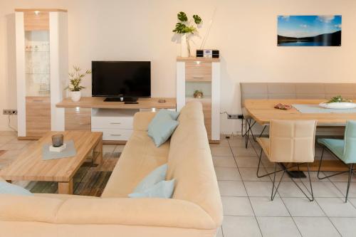 a living room with a couch and a table at Landgasthof Tönnes in Wipperfürth