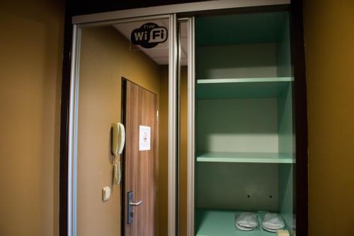a glass door to a locker room with shoes in it at Balu Apartments in Prague
