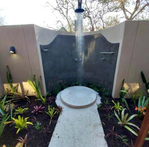 a fountain in the middle of a garden at 13 Raptors Lodge in Hoedspruit