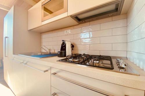 a kitchen with a stove and a counter top at Studio de Poeti in Bologna