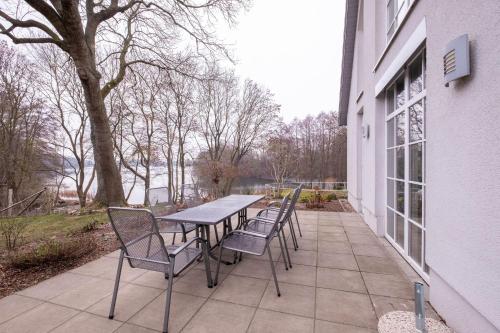 a table and chairs sitting on a patio at Herrenhaus Jürgenshof - Ferienhaus in Alt Schwerin