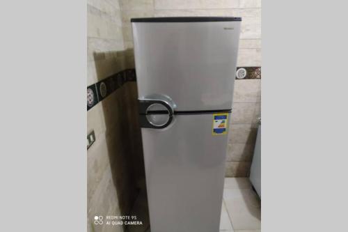 a refrigerator in a room with a wall at Full Flat cozy place terrific view in Cairo