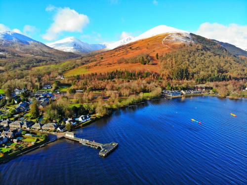an aerial view of a lake in front of a mountain at The Lodge On Loch Lomond Hotel in Luss
