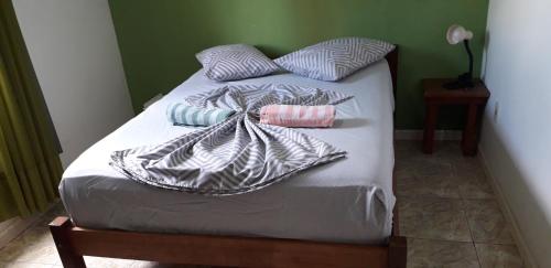 Una cama con dos almohadas encima. en Niko Residencial, en Florianópolis
