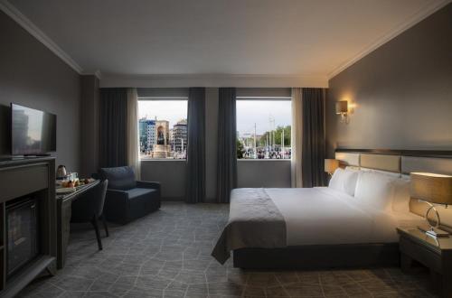 a hotel room with a large bed and a television at Taksim Square Hotel in Istanbul
