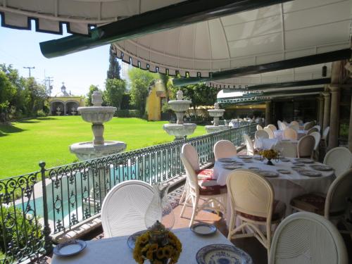 a row of tables and chairs on a balcony at Gran Hotel Hacienda De La Noria in Aguascalientes