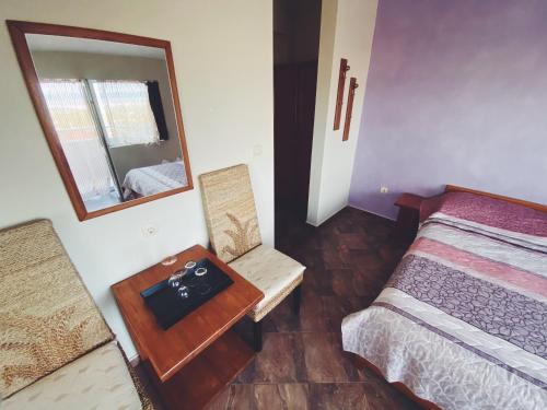 a bedroom with a bed and a mirror and a table at Hotel Fancy in Sofia