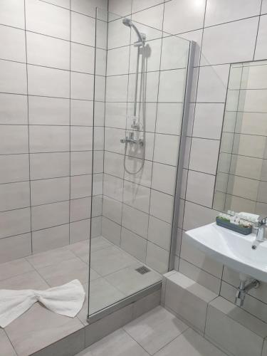 a bathroom with a shower and a sink at LEX Trend Hotel in Irpin'