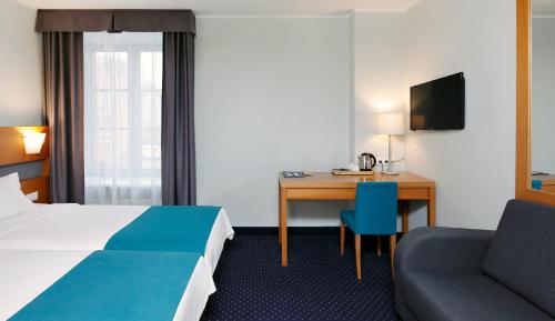 Säng eller sängar i ett rum på Hestia Hotel Ilmarine
