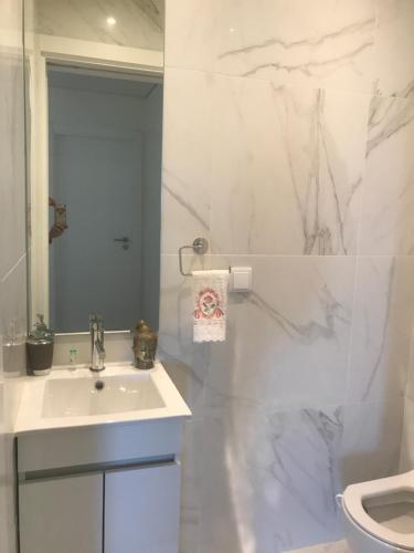 a white bathroom with a sink and a toilet at Modern Double Room with Private Balcony in Montijo