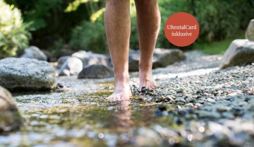 a person walking on a rocky path near a river at Seebrunn - Außere Schwemmalm in Ultimo