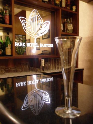 a wine glass sitting on top of a bar at Park Hotel Fantoni in Tabiano