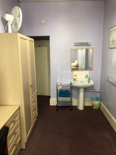 a bathroom with a sink and a mirror at St. James's Guest House in London