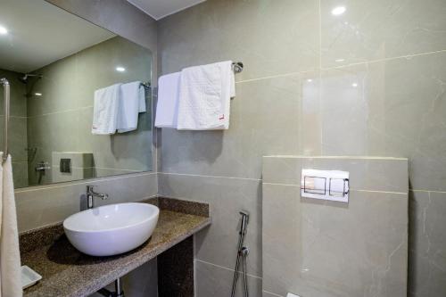 a bathroom with a sink and a mirror at De Lagom Comforts, Anjuna Beach - A boutique hotel in Anjuna