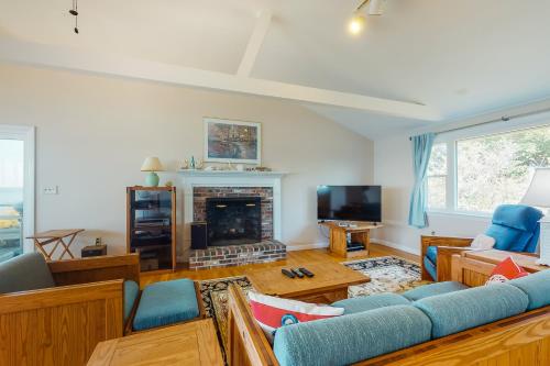 a living room with a couch and a fireplace at Beaches n' Sunsets in Eastham