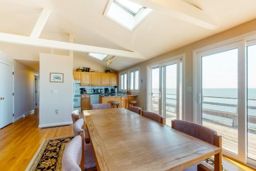 a kitchen and dining room with a table and chairs at Beaches n' Sunsets in Eastham