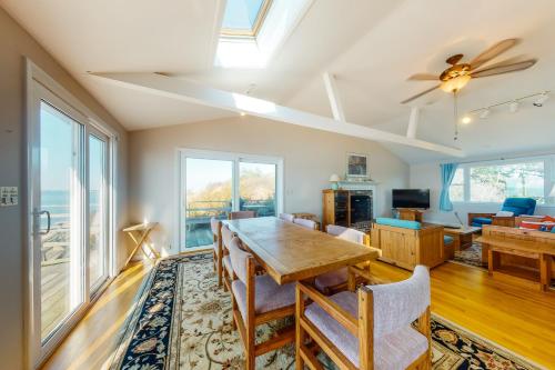 a dining room with a table and chairs and a ceiling fan at Beaches n' Sunsets in Eastham