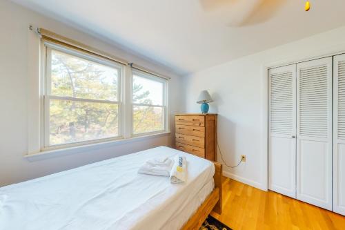 a bedroom with a bed and two windows at Beaches n' Sunsets in Eastham