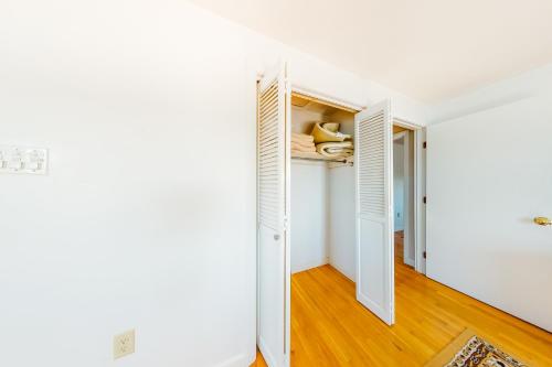 a hallway with an open door and a closet at Beaches n' Sunsets in Eastham