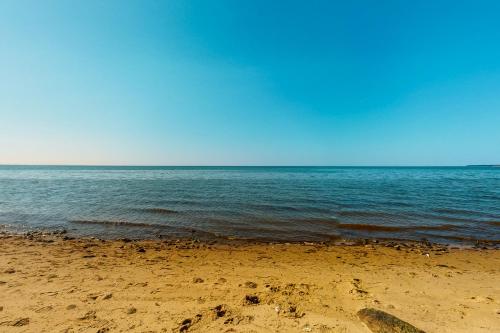a sandy beach with the ocean in the background at Beaches n' Sunsets in Eastham