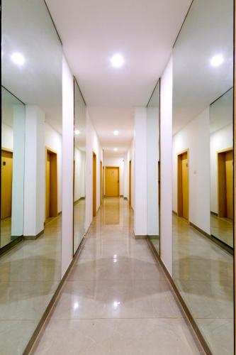 an empty hallway in a building with mirrors at De Lagom Comforts, Anjuna Beach - A boutique hotel in Anjuna