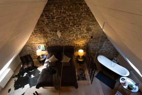 an overhead view of a living room with a stone wall at Riverside Cottage Dinant in Dinant