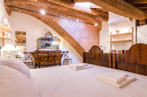 a bedroom with a large white bed in a room at Altabella Panoramic Tower in Bologna