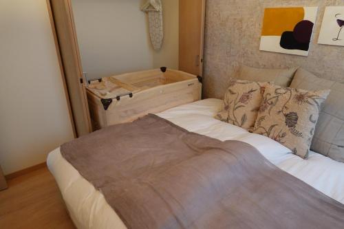 a small bedroom with a bed and a dresser at beautiful Mt.Fuji B in Fujikawaguchiko