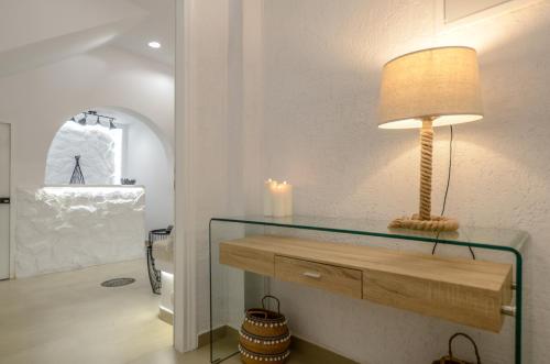 a lamp on a glass table in a room at Saint George Hotel in Naxos Chora