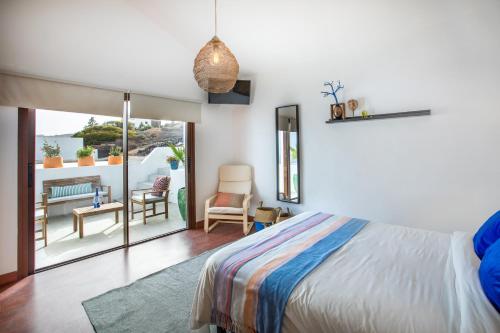 a bedroom with a bed and a balcony at Villa Atlantis I in La Asomada