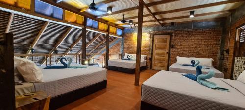 a room with three beds with blue stuffed animals on them at Rumah Bendang Langkawi Villa Pool in Pantai Cenang