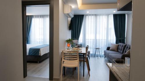 a living room with a bed and a dining room at OPERA SUITES Apart Hotel in Antalya