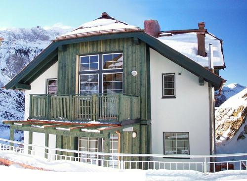 a house with a balcony in the snow at Ferienwohnung Anderl in Obertauern