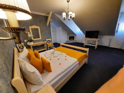 a bedroom with a large bed with orange pillows at Select House in Sibiu