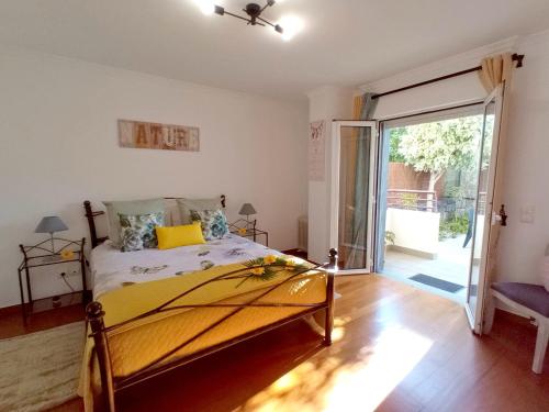 a bedroom with a bed and a sliding glass door at Garden's Apartment in Funchal